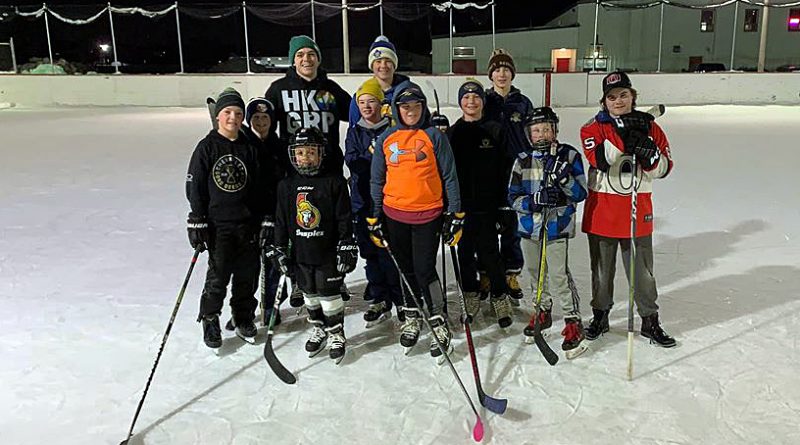 A group of skaters pose on the Carp outdoor rink.