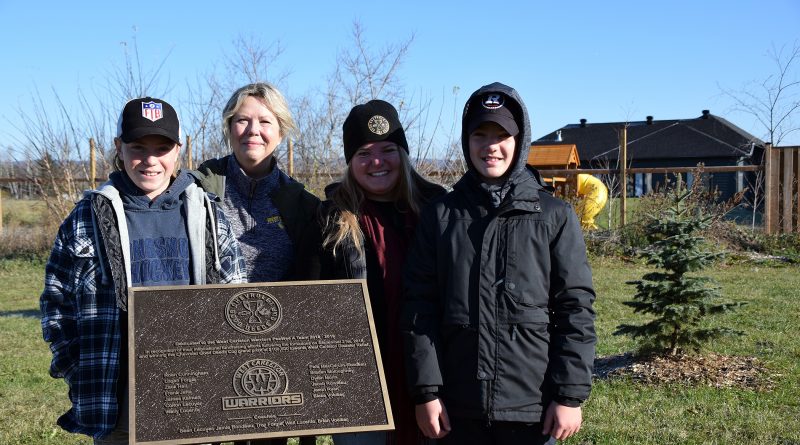 From left, Warriors Zack Hall, Kim Wood, Shelley Welsh and Blake Voelker pose with a plaque honouring the West Carleton Warriors' fundraising efforts.