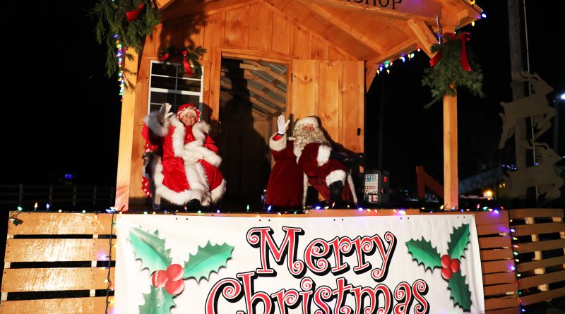 Santa and Mrs. Claus greet visitors to the 11th Annual Carp Santa Parade - Drive Thru Style, Saturday night.