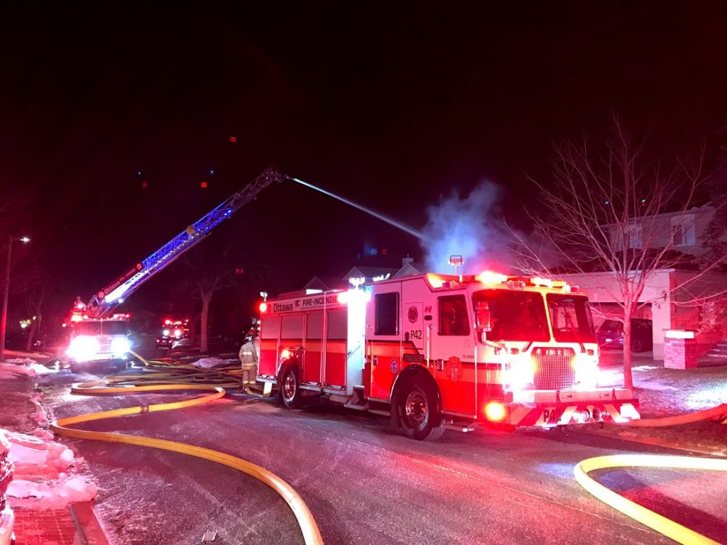 An Ottawa fire ladder truck battles the blaze.