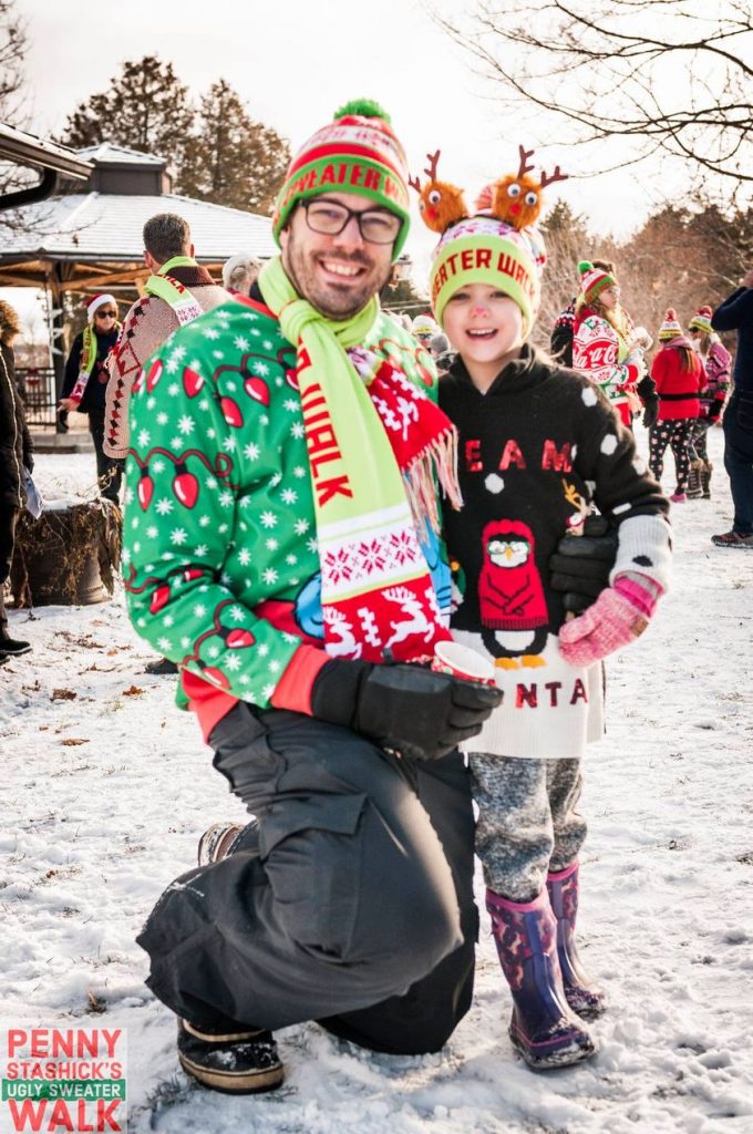 Event organizer Derek Stashik poses with his daughte at last year's Ugly Sweater Walk.