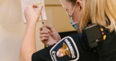 An Ottawa paramedic handles the COVID-19 vaccine.