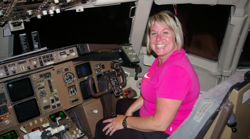 Theresa Fritz poses in the cockpit of a plane.