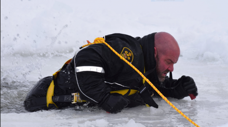 OPP Const. Sean McCaffrey shows how to escape falling through the ice during a demonstration on Feb. 17. Courtesy the OPP