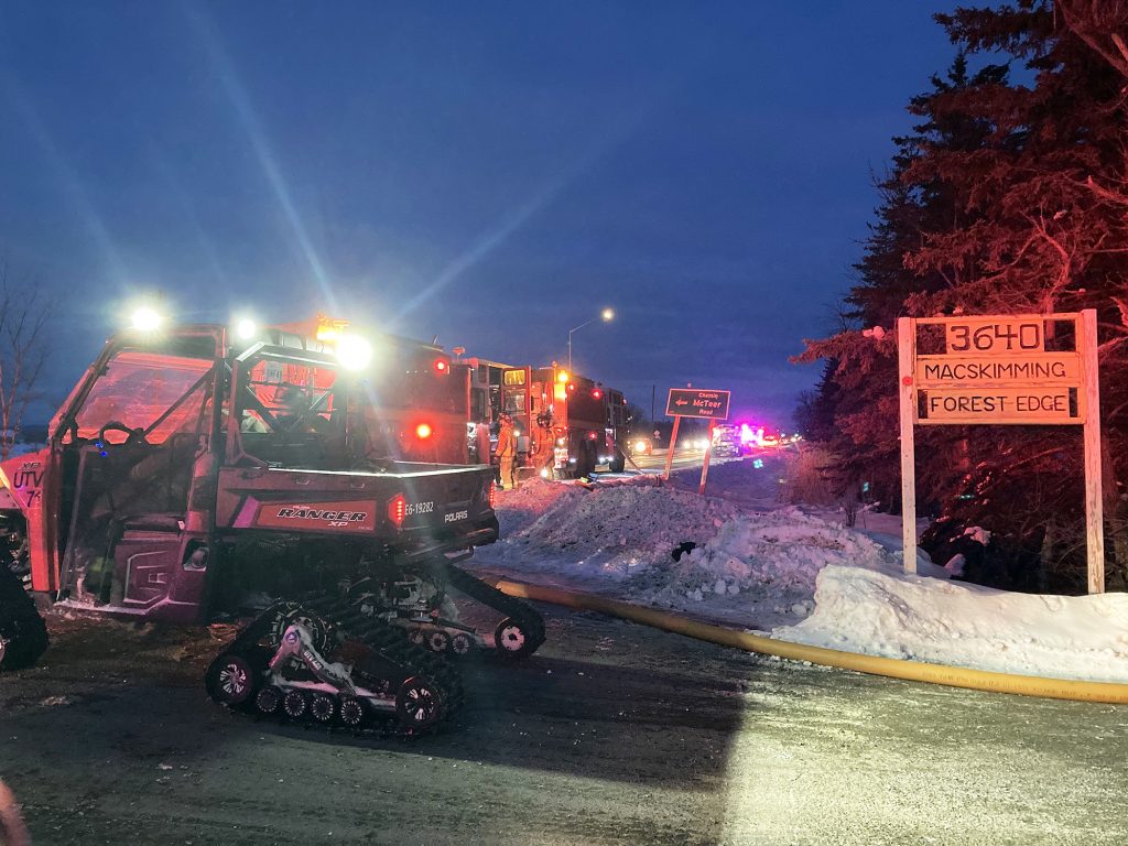 An OFS ATV helps transfer firefighters down the long lane way.