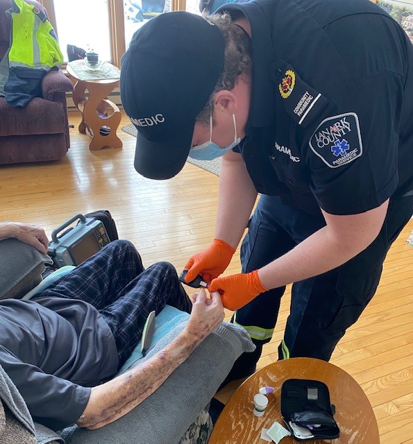 A community paramedic performs a home visit.