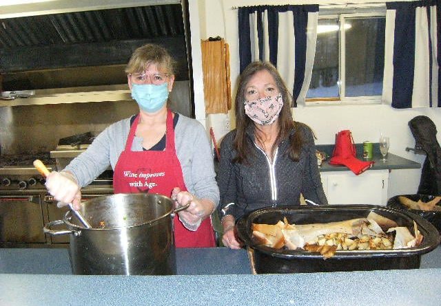 Legion volunteers Sue Johnson and Anita Kamps work on roast park dinner on Feb. 26 for Branch 616 Meals to Wheels program. Courtesy Branch 616