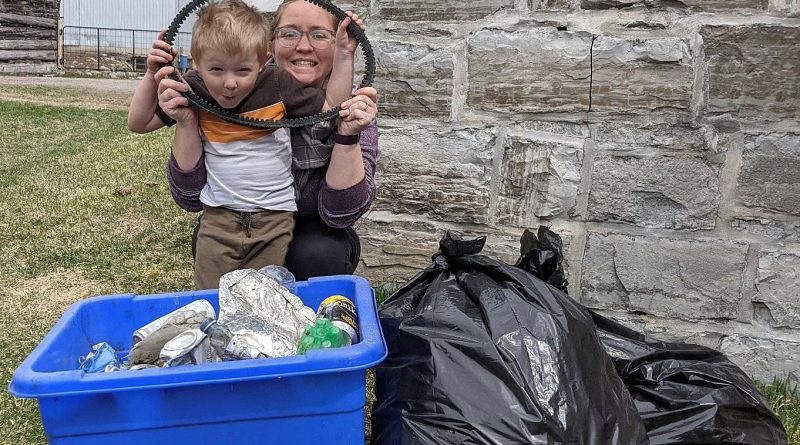 Bethany Braun and her son Weston show off their haul after spending time cleaning a one-kilometre stretch of Kinburn Side Road. Photo by Adam Braun
