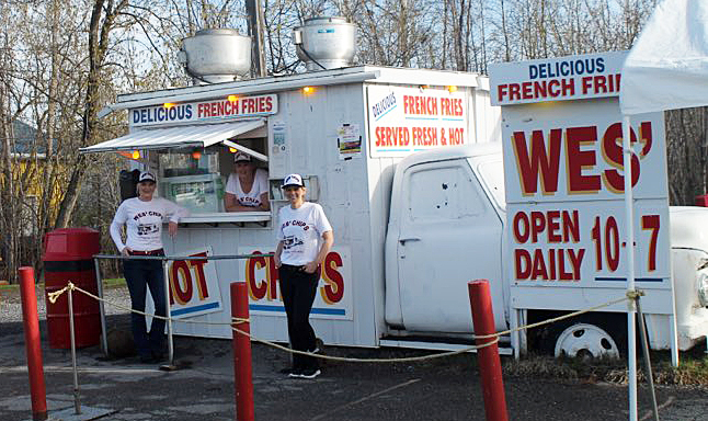 New owners Lisa, Julie and Tanya Hordijczuk pose in front of Wes' Chips.