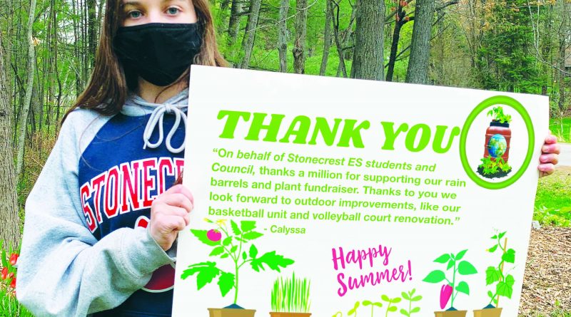 A photo of a Stonecrest student holding a thank you sign.