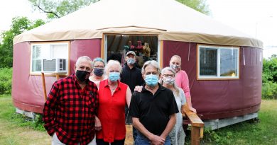 A photo of the Bowen family in front of the new yurt.