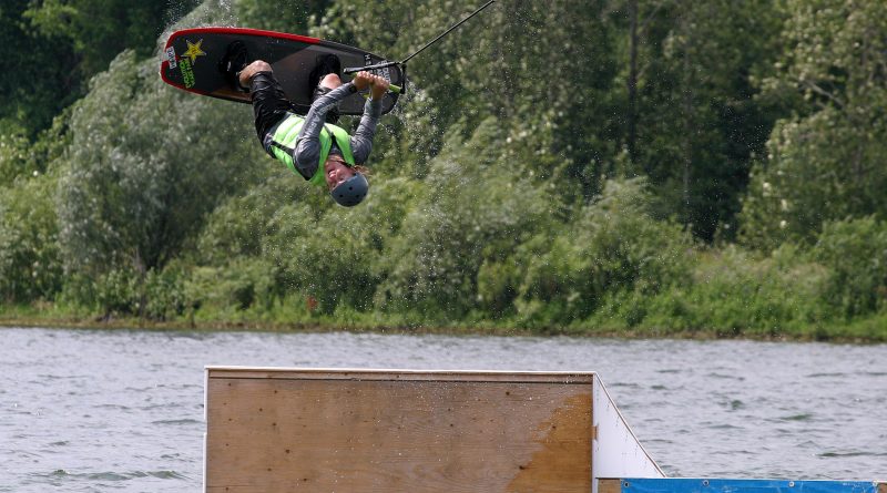 A photo of Jordan Sien doing a flip on a wakeboard.