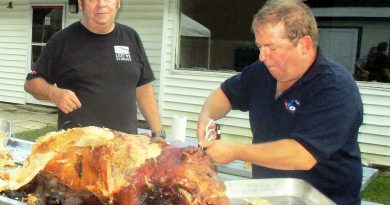 Barry Milks and John Woodbeck work on a pig in 2018.