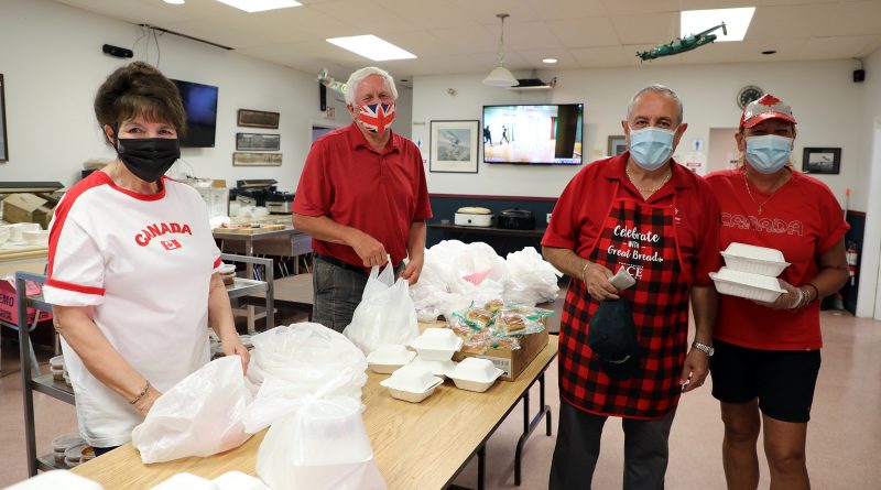 A photo of volunteers preparing the Canada Day Meals to Wheels dinner.