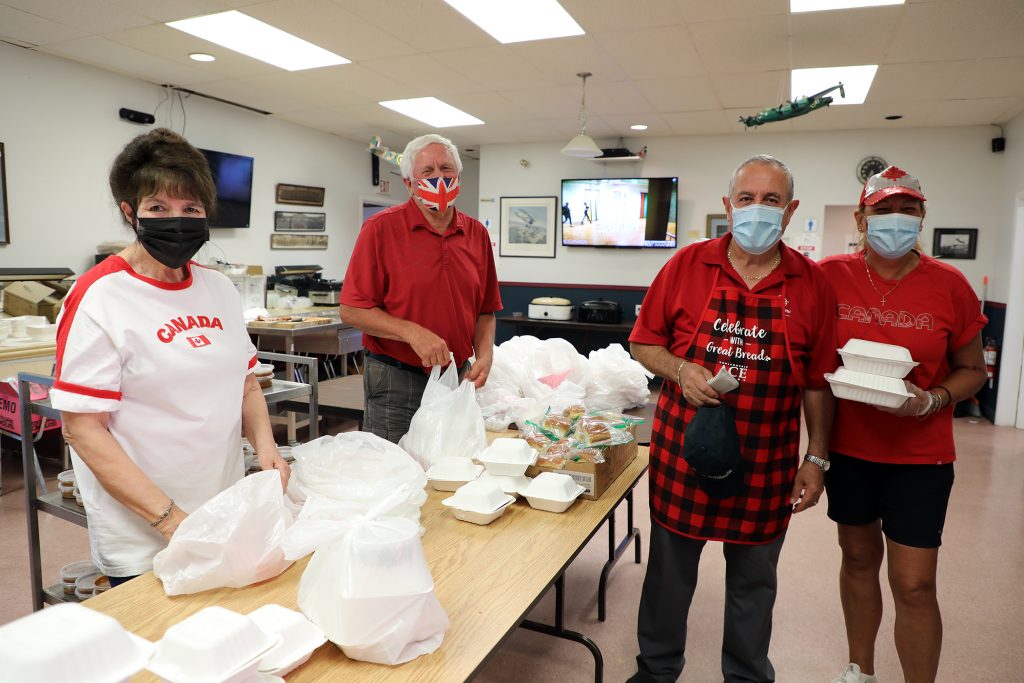Legion volunteers pack Canada Day meals.