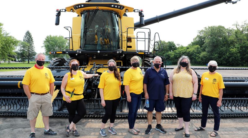 From left, volunteer and farmer Jason Nicholson, Alicia Becker, Jean Sullivan, Coun. Eli El-Chantiry, Mississippi Mills Mayor Christa Lowry and Farm and Food Care Ontario chair Bonnie den Haan pose in front of some million-dollar farm equipment. Photo by Jake Davies
