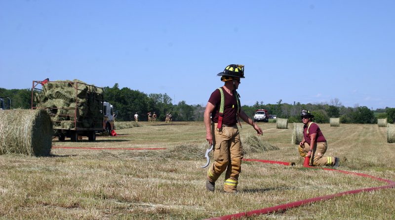 A photo of firefighters battling a grass fire in Kinburn.