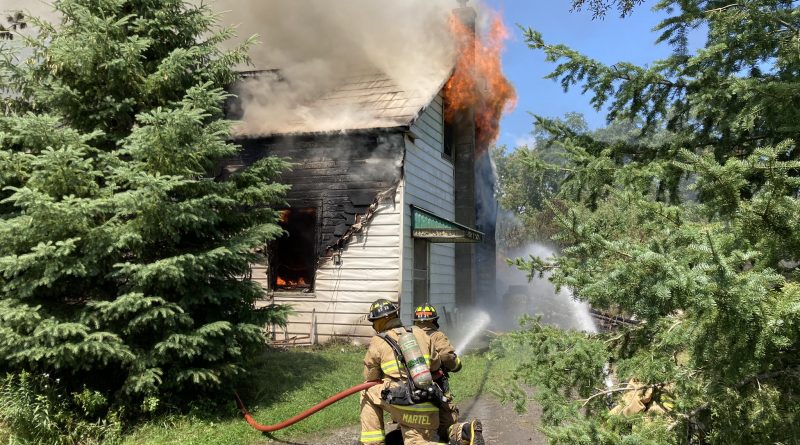 Firefighters battle a house fire.