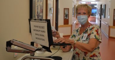 Registered Practical Nurse Cathy Porteous uses the secure medication cart at Fairview Manor.