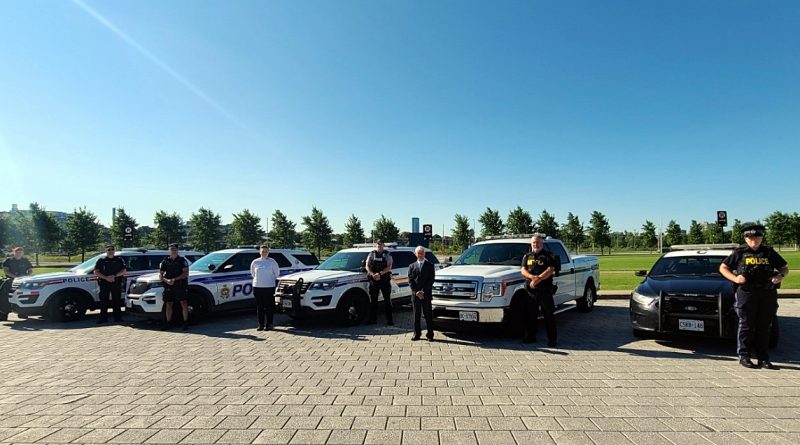 A photo of four police forces and their vehicles.
