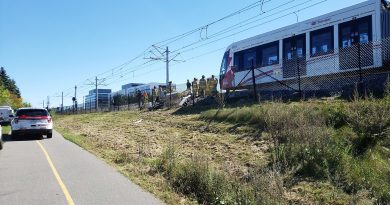 Firefighters ensure the derailed LRT train is stable for Transportation Safety Board investigators. Photo by Steven Grant
