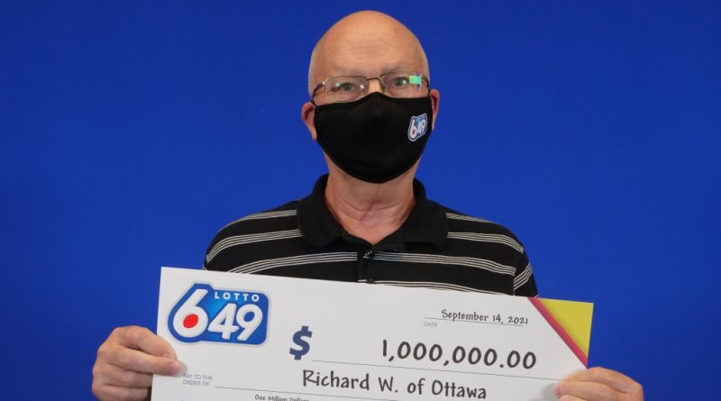 Richard Wiles shows off his really big cheque.
