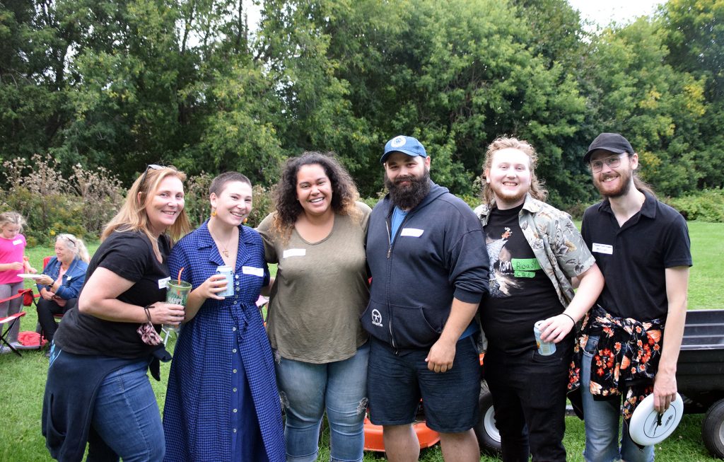 Six villagers pose for a photo.