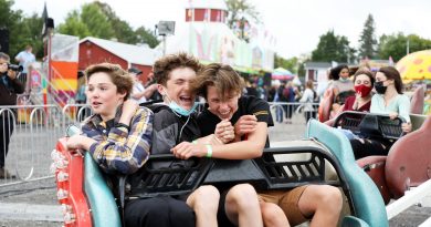 Three teenagers take a ride on the Sizzler.