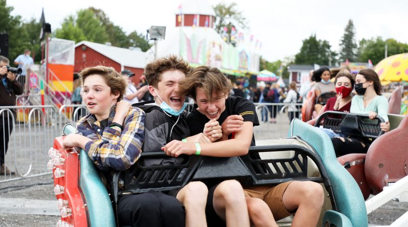 Three teenagers take a ride on the Sizzler.