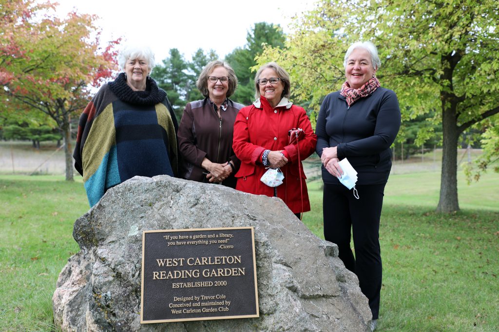 A photo of four members of the garden glub in the reading garden.