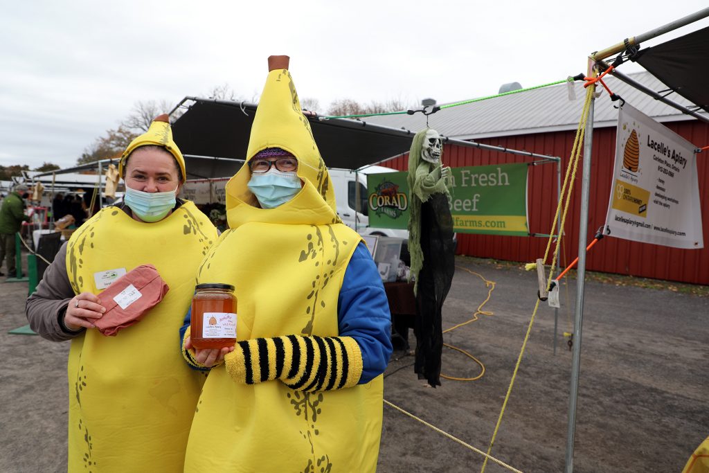 Two vendors dressed as bannanas at the farmers' market.