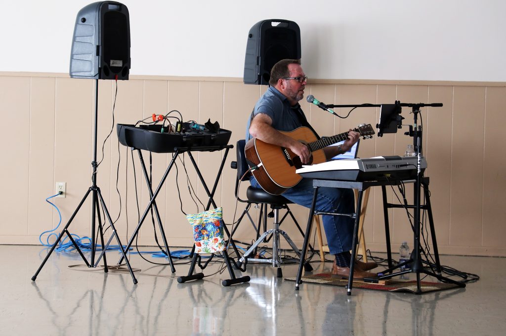 A photo of Rick Leben singing.