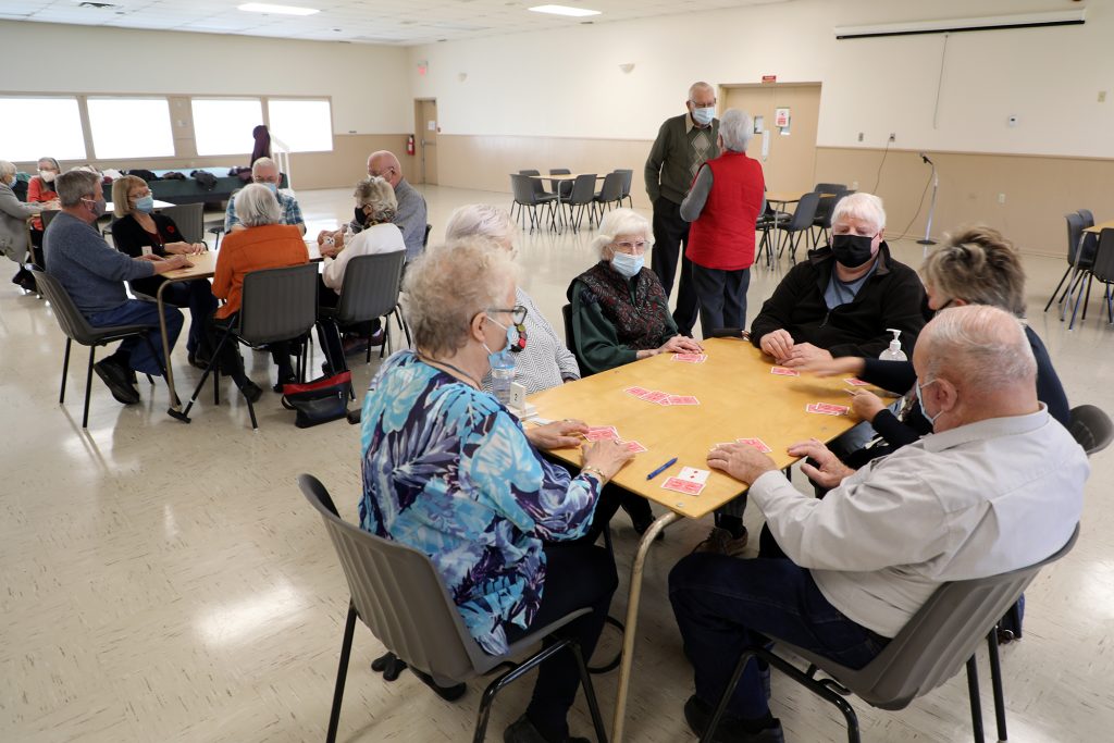 A photo of three tables playing euchre.