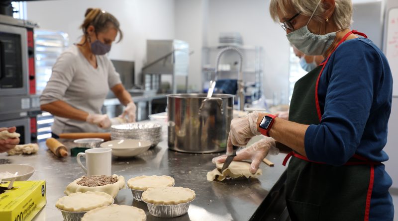 A photo of volunteers making pies.