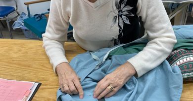 A photo of Alexis Barr sewing.
