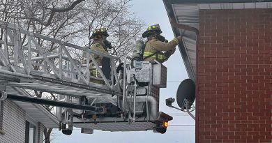 A photo of firefighters venting a roof.