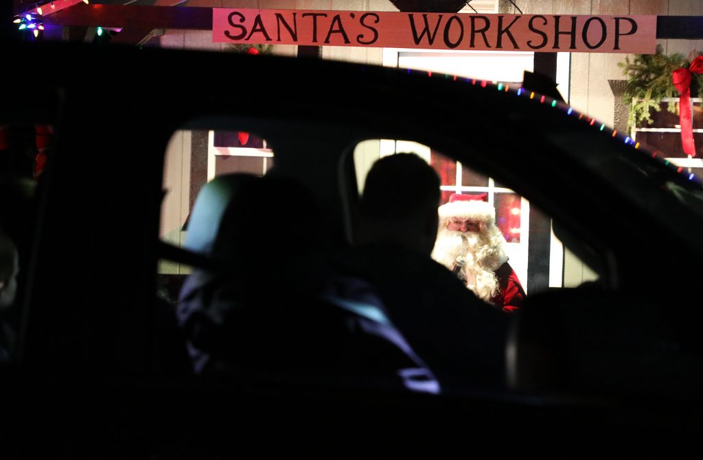 A photo of Santa talking to a van.