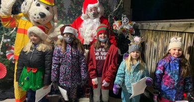 A photo of Sparky, Santa and the community choir.