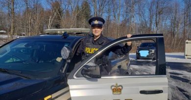 A photo of Const. Megan Scully at her cruiser.