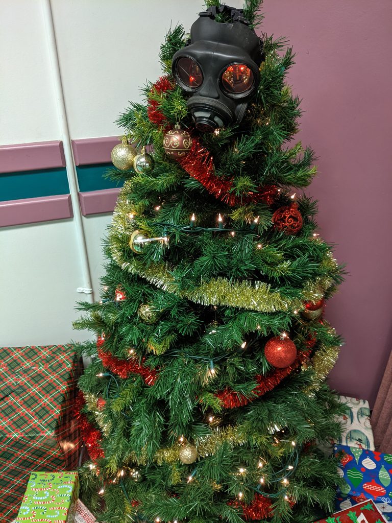 A photo of a Christmas tree with a gas mask.