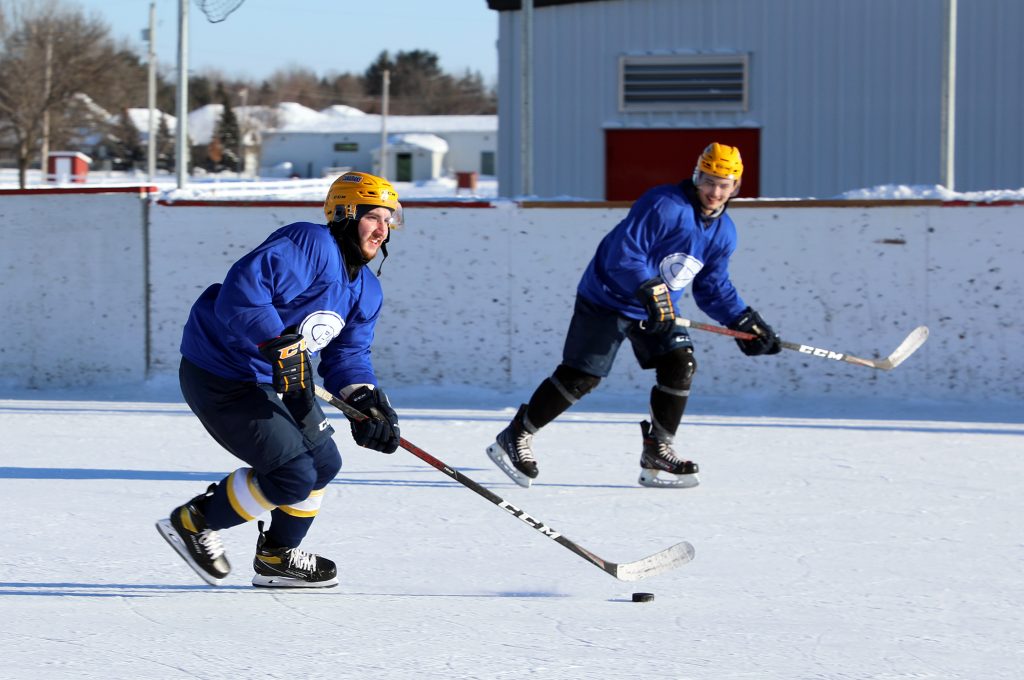 Canadians players streak up the ice.