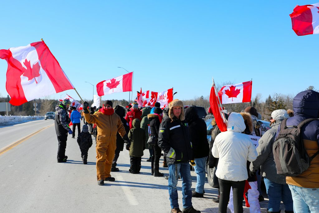 A photo of convoy supporters waving flags on the March Road overpass.