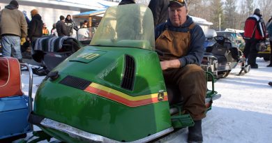 A photo of a classic John Deere snowmobile.