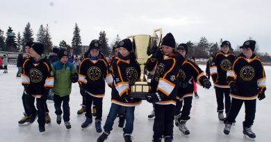 A photo of hockey players carrying the Good Deeds Cup.