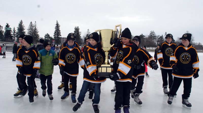 A photo of hockey players carrying the Good Deeds Cup.