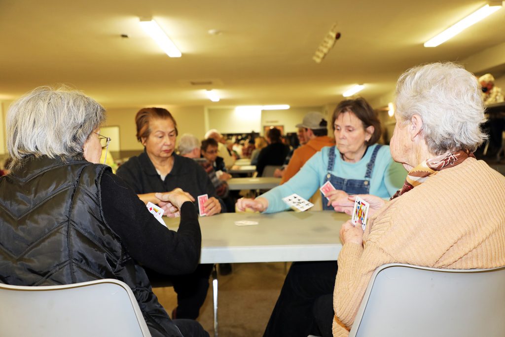 A photo of peope playing cards.