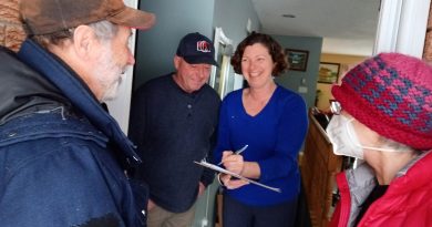 A photo of Mary Jo and David Morrison getting their petition signed.