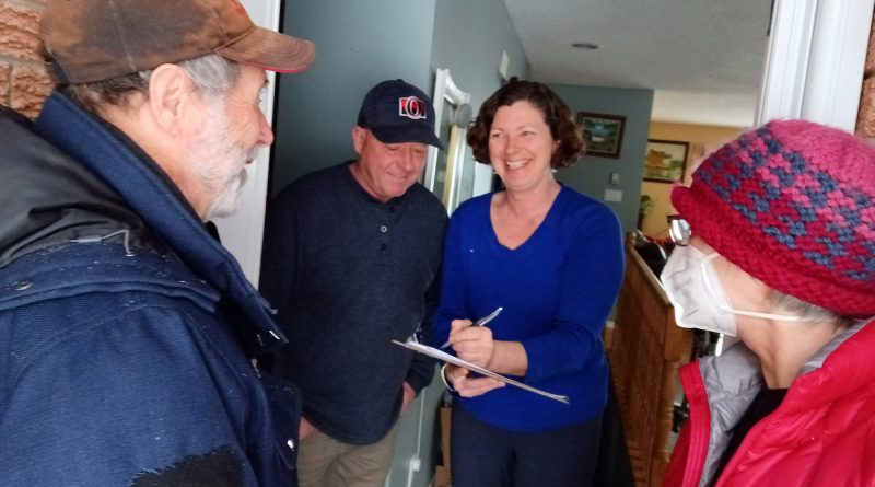 A photo of Mary Jo and David Morrison getting their petition signed.