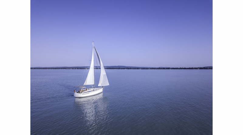 A sailboat heads out to sea.