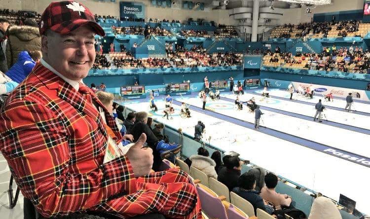 A photo of Todd Nicholson attending a curling match.